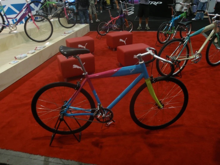 two blue and pink bikes parked next to each other on red carpet