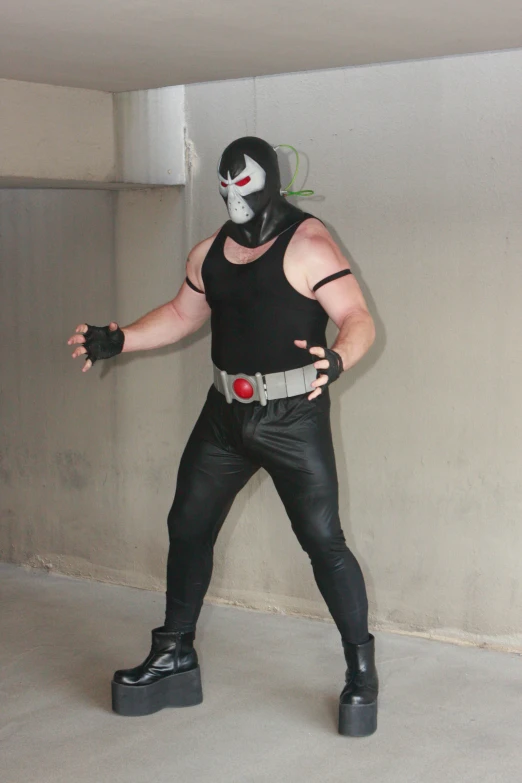 a male in a black shirt and leggings posing