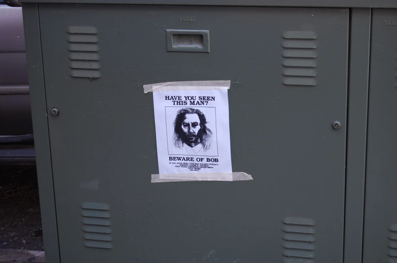 a bulletin taped to the side of a gray locker