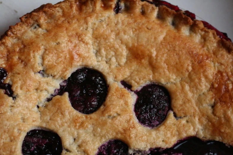 a pie is shown with blueberries in it