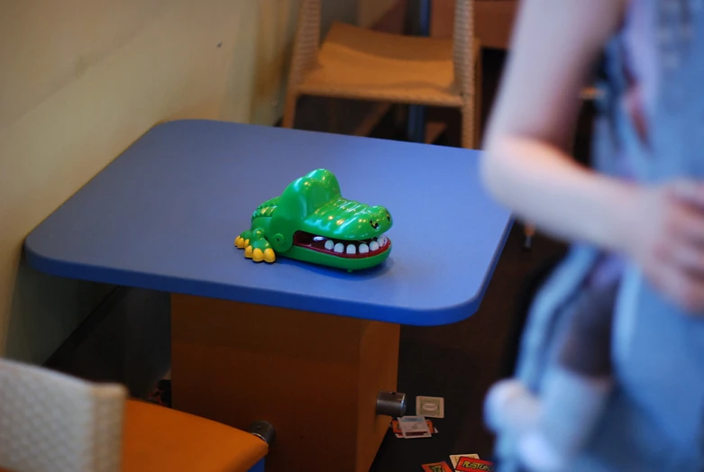 small children's toy car with fake teeth on the table