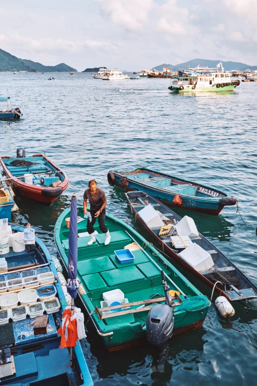 a person is bending over the bottom of some boats