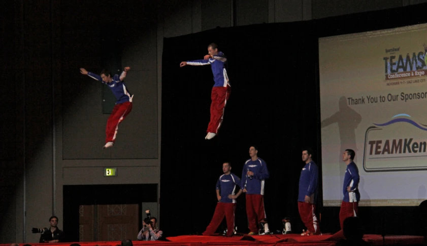 several people at an event doing tricks on stage