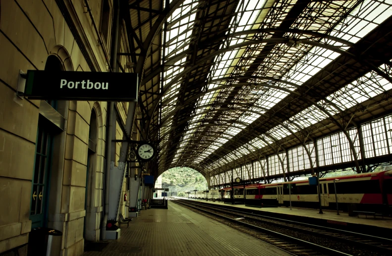 a train station with multiple trains passing by