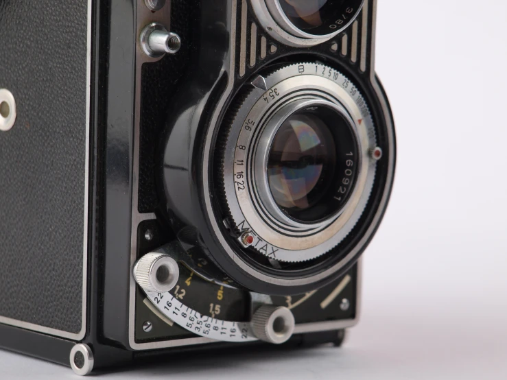 an old fashioned camera is black in color