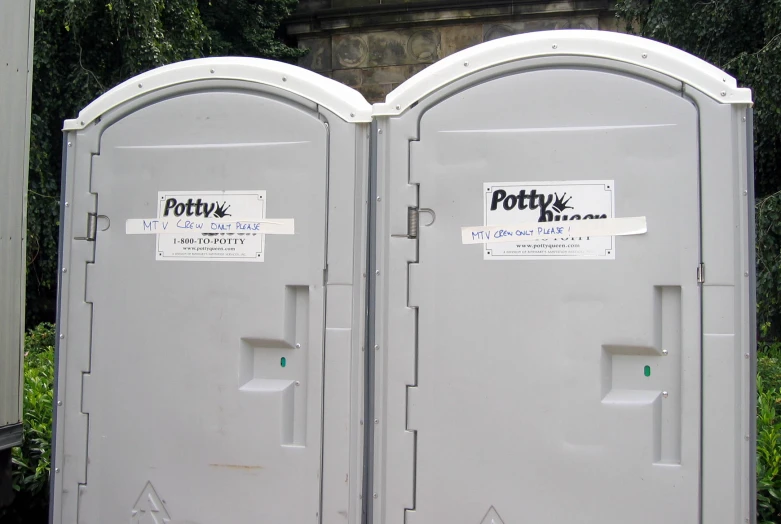 two portable toilets sitting outside next to each other