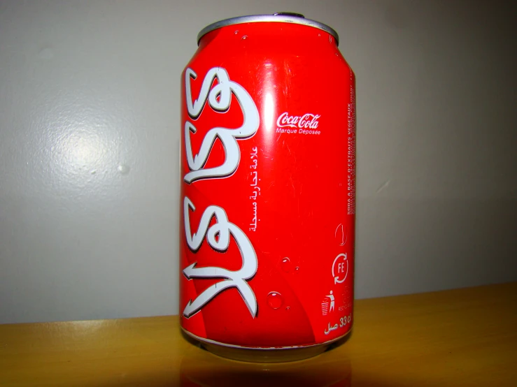 a red soda can with the word coca - cola painted on it