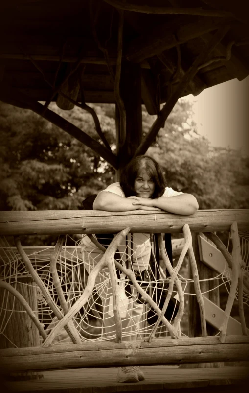 the girl is sleeping on the wooden bench