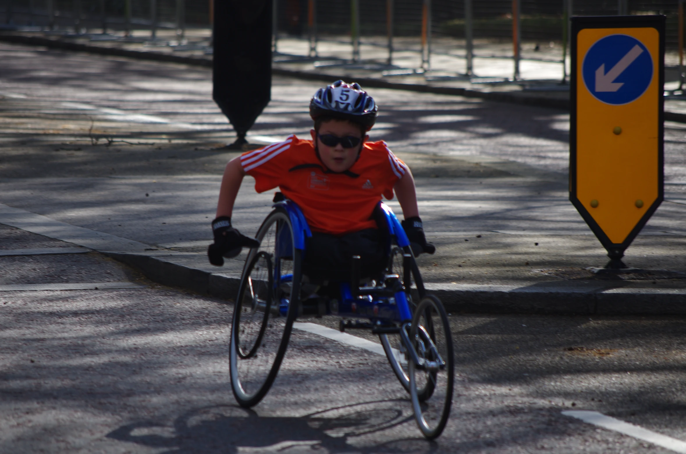 a boy in a wheel chair riding a bike