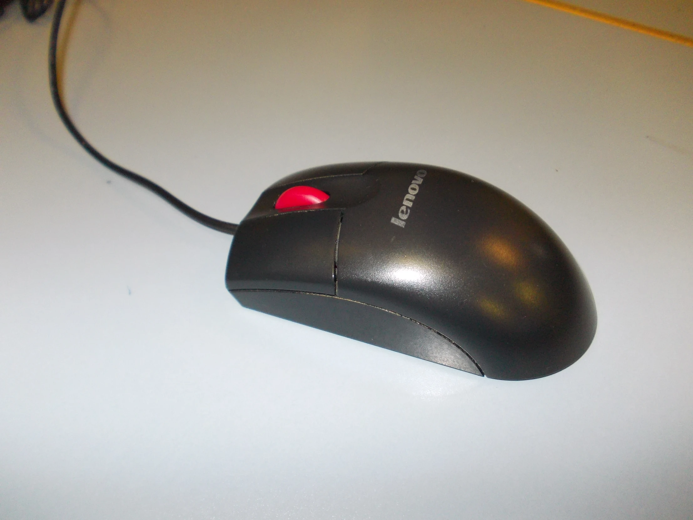 the back side of a mouse with red ons