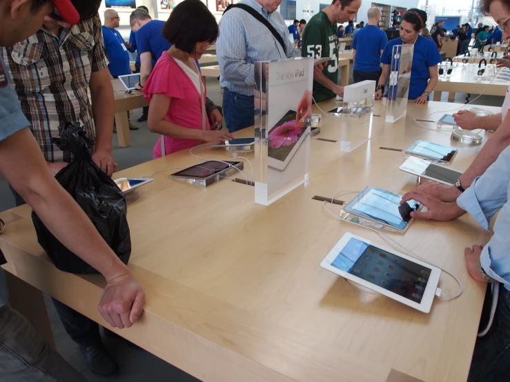 a man is looking at a tablet next to a table