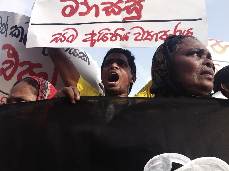 some people are protesting with red and black signs