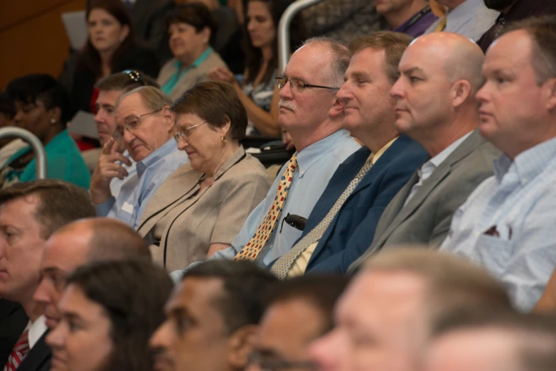 a large group of people sitting down looking at soing