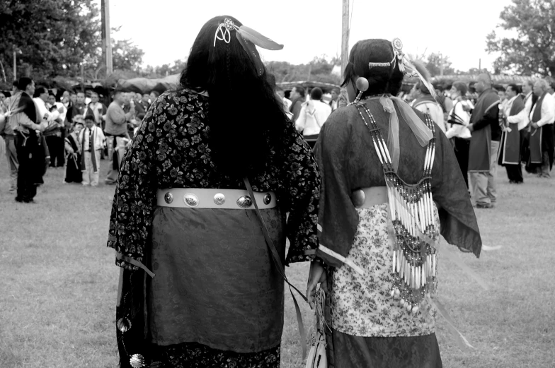 two people dressed as samurais in front of a crowd