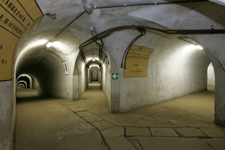 an abandoned tunnel with some signs on the walls