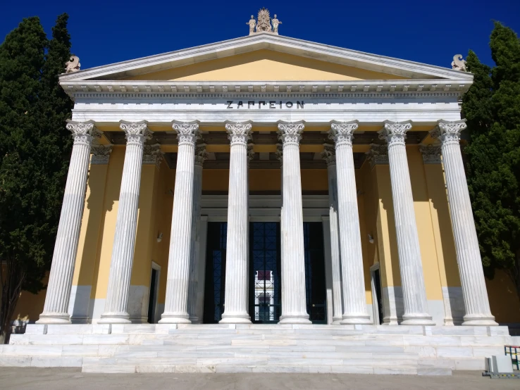 the entrance of a building with two pillars and a column