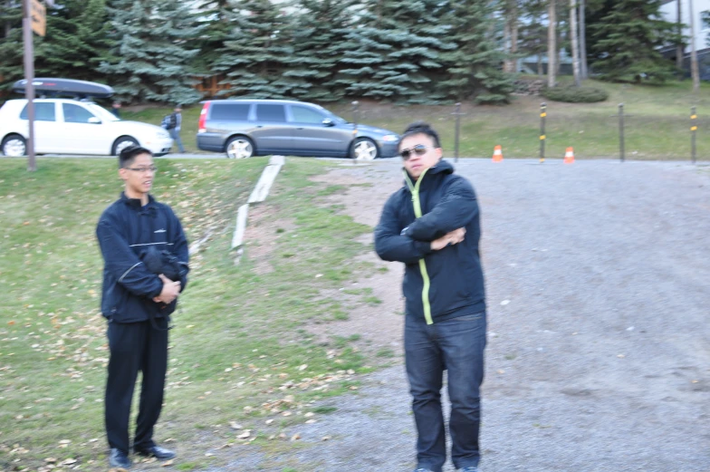 two people stand in front of the road