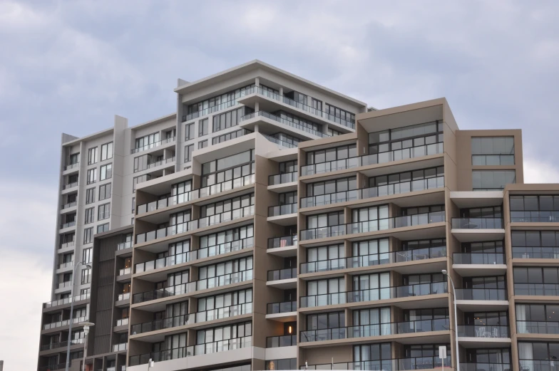 a tall multi - story building with large windows on top