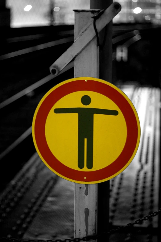 there is a sign warning of men crossing a subway