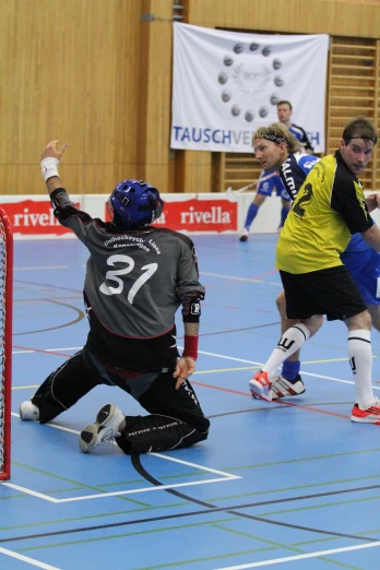 several men playing a game of indoor hockey