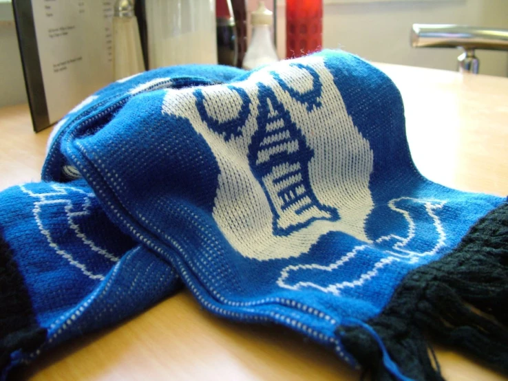 a pair of blue and white knit hats on a table