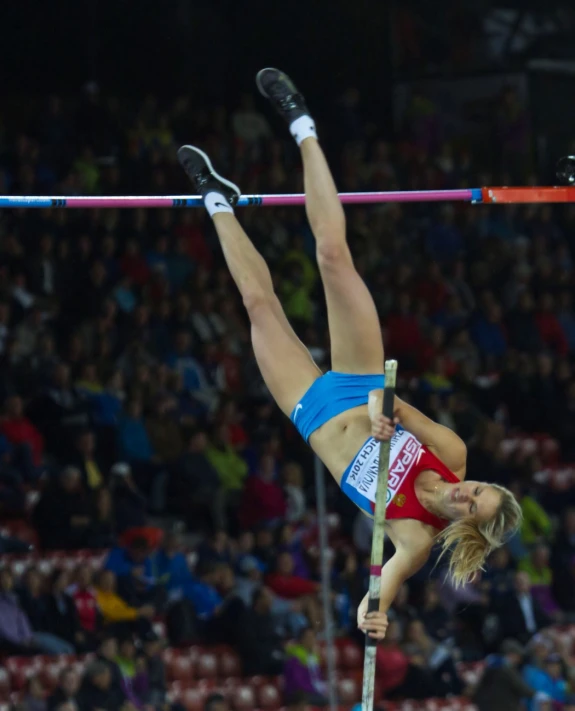 the women is performing a stunt on the pole