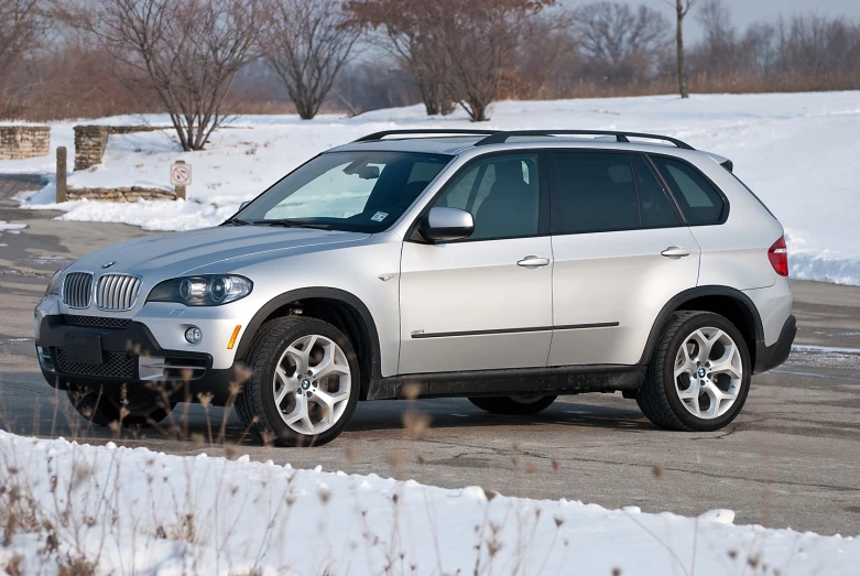 the suv is driving on a snowy street