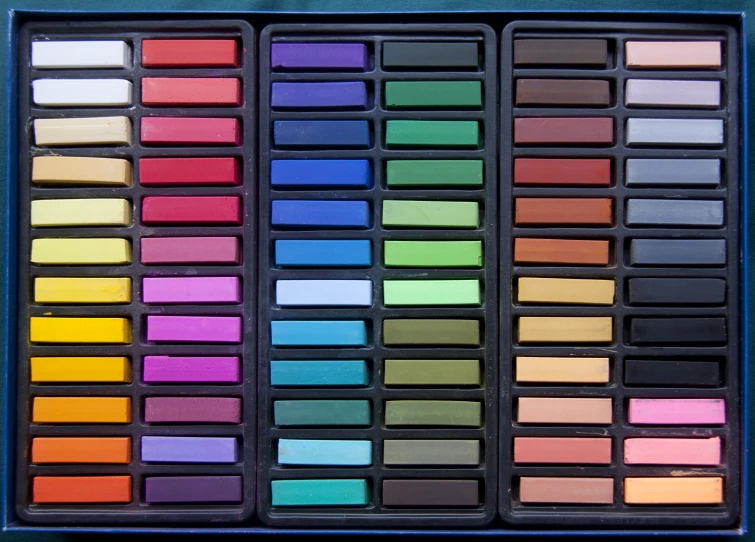 an art palette in a blue case containing one of the colors and five different colors