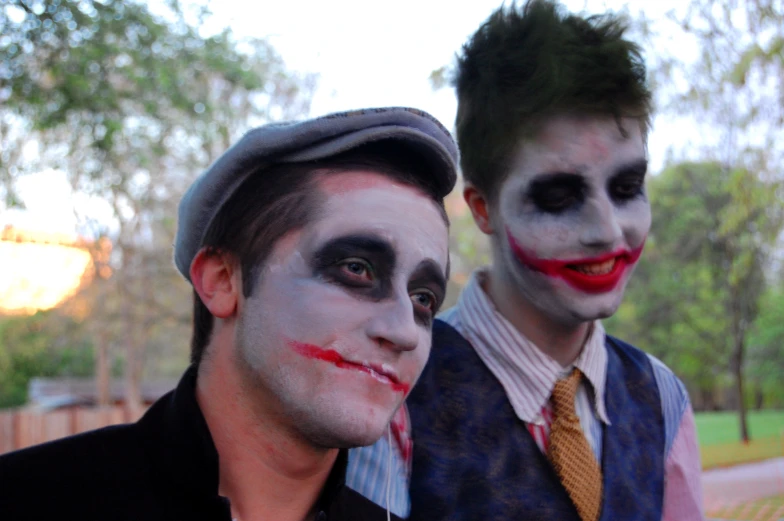 two men with their faces painted in white