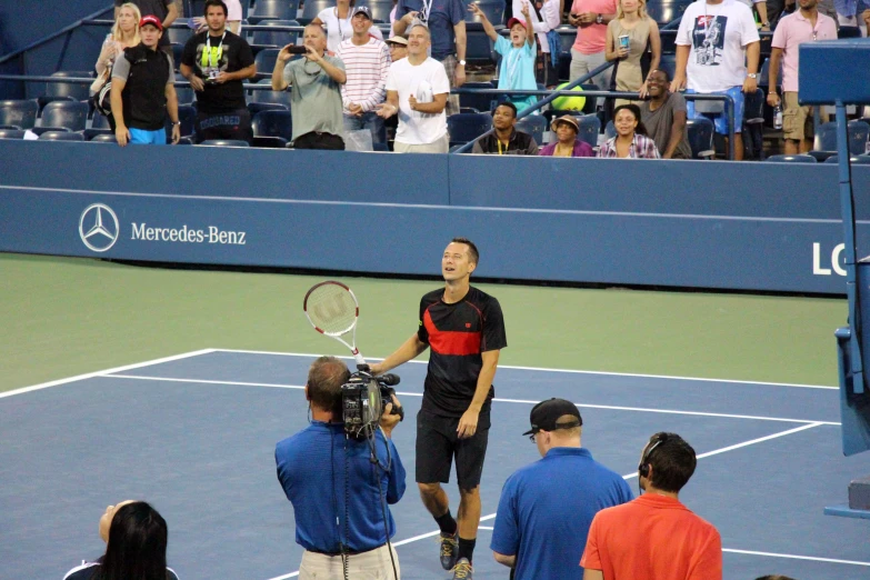 a man stands at the net during a tennis match