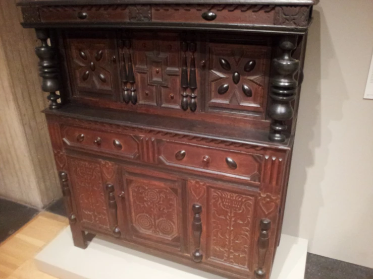 an old wooden cabinet with carved carvings and drawers