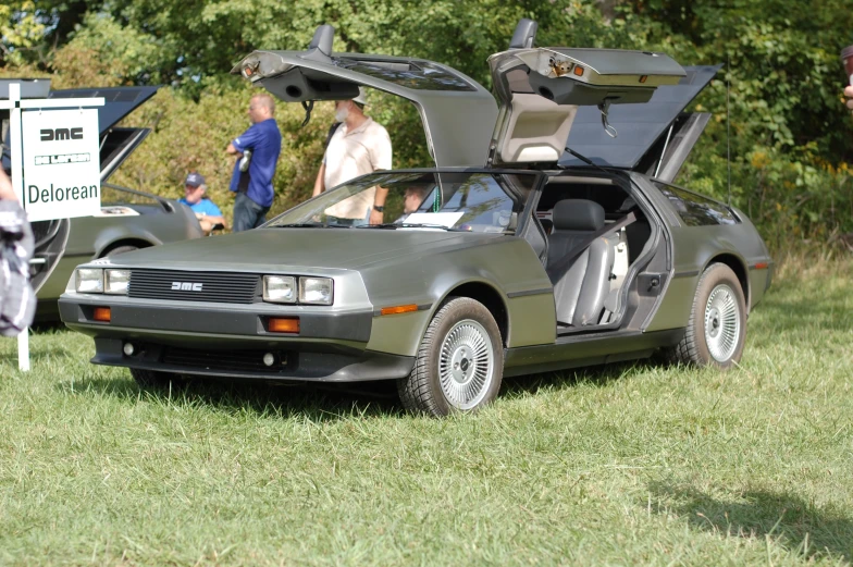 people look at delored cars and their belongings on display