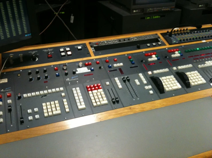 an analog mixing desk with many ons and numbers