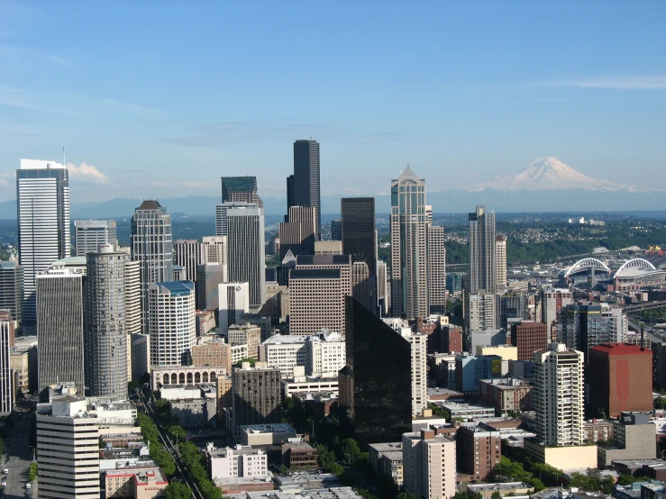 an aerial view of a city with mountains in the background