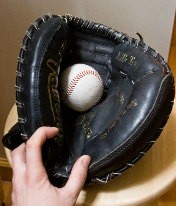 the man is showing off his baseball mitt