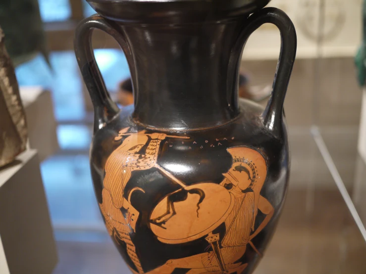 the vase is decorated with stylized pictures of men