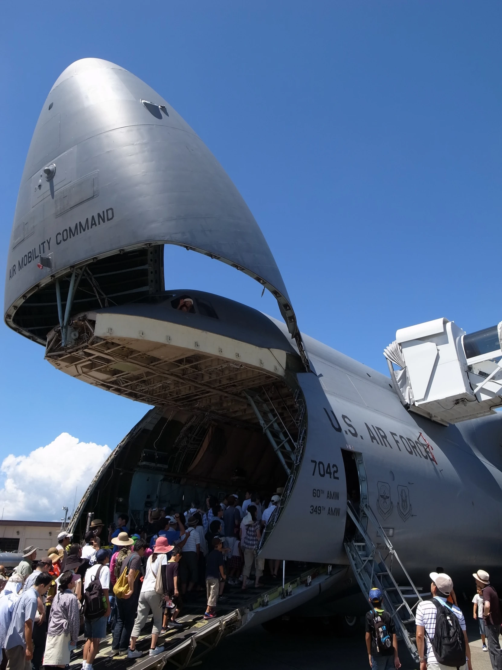 a group of people are boarding a large aircraft