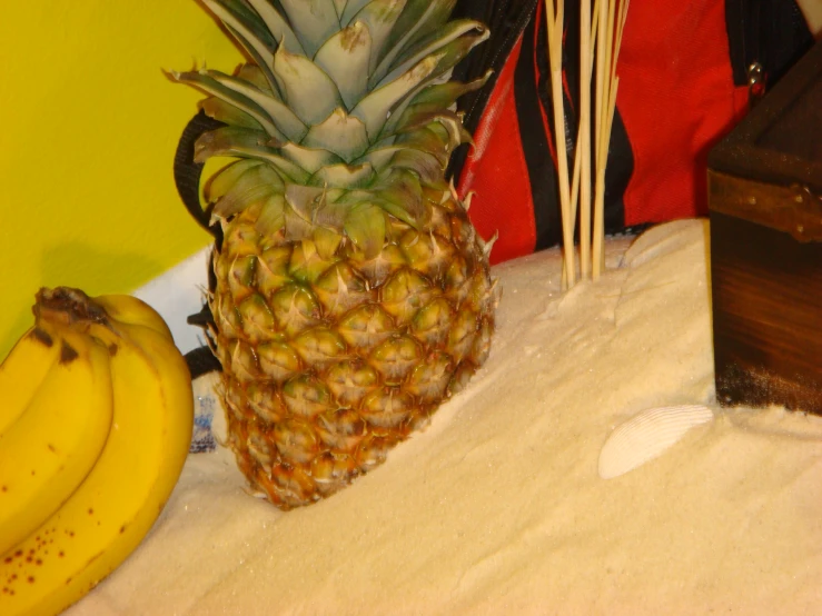 a close up of a pineapple and two bananas