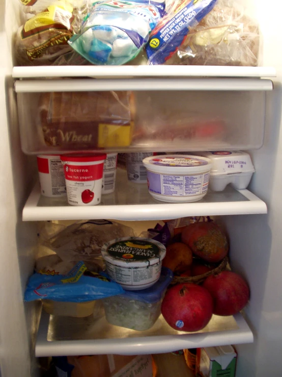 a refrigerator with the door open to the food in it