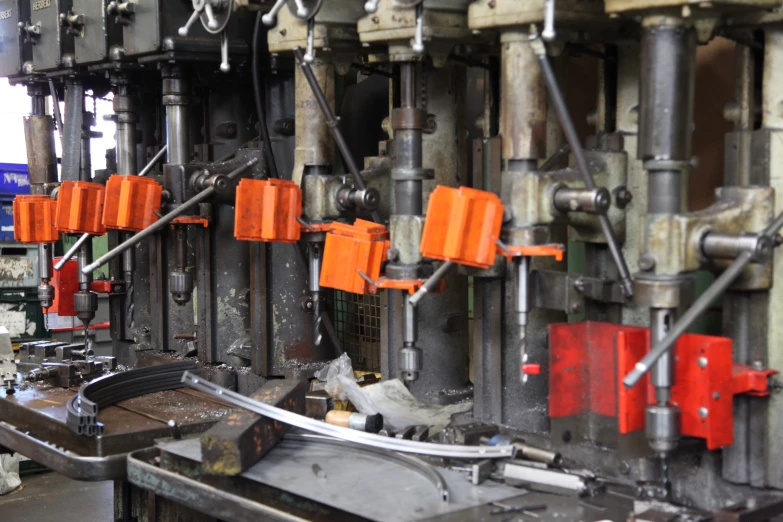 an industrial machine making a line of orange items