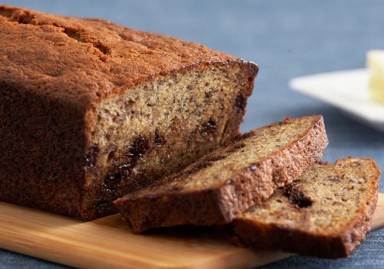 a loaf of banana nut bread with one slice cut off