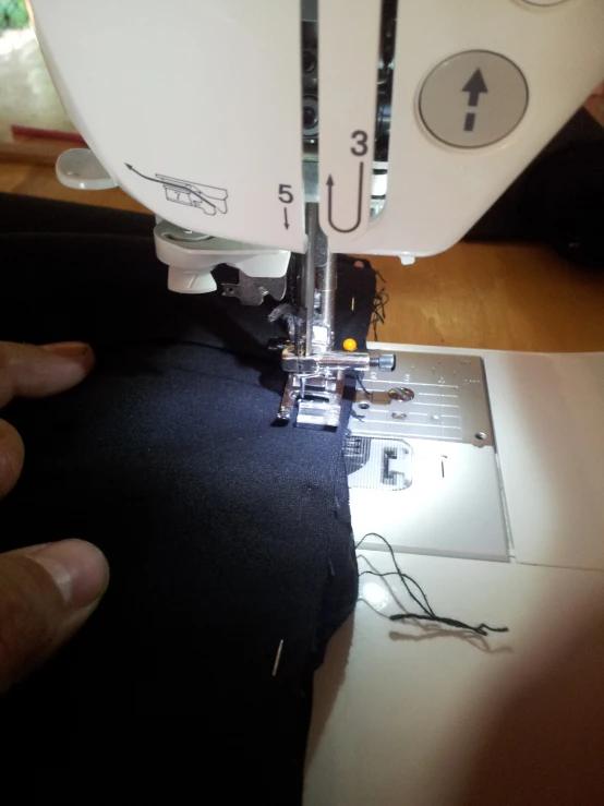 a person is working with the sewing machine