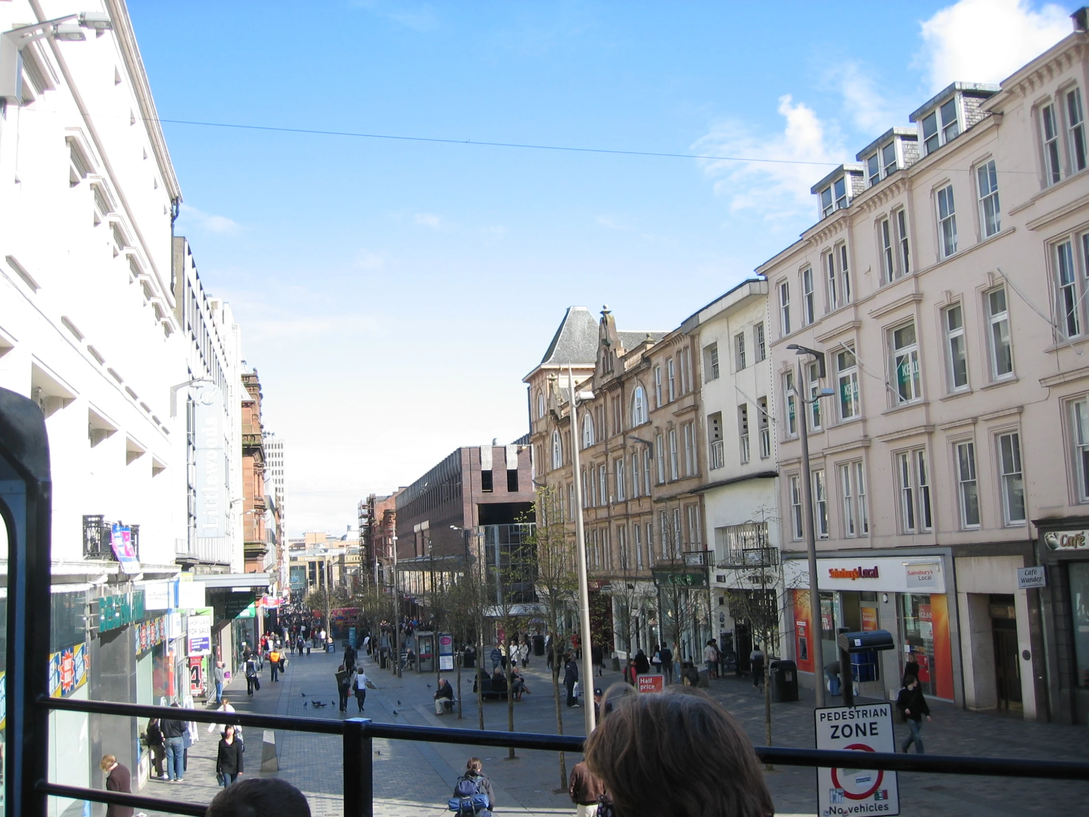 a town street scene with several people walking down the street