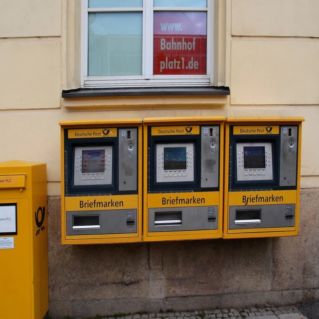 three vending machines lined up in front of a window