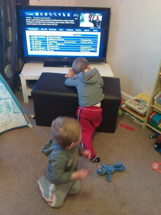 two small children playing a game on the wii console