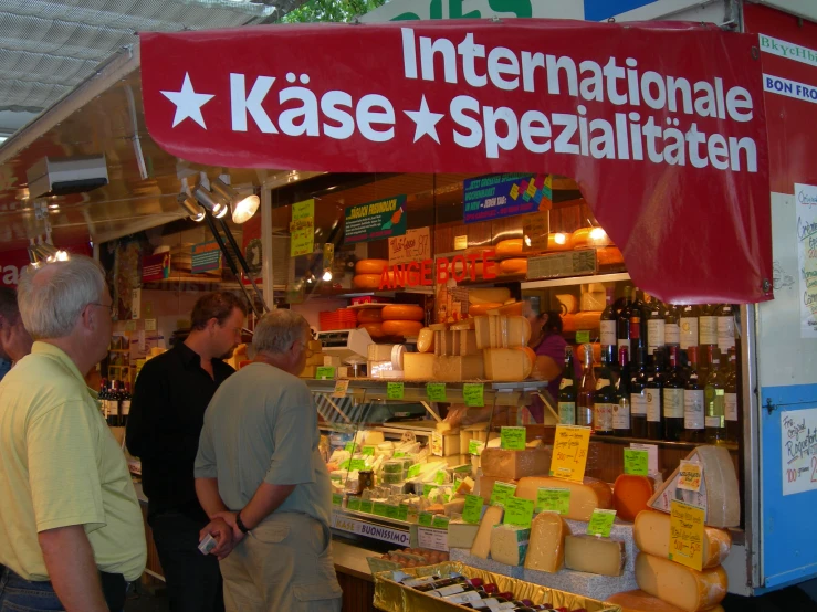 several people are shopping at an outdoor market