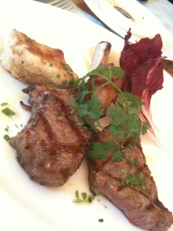 a white plate topped with meat and vegetables