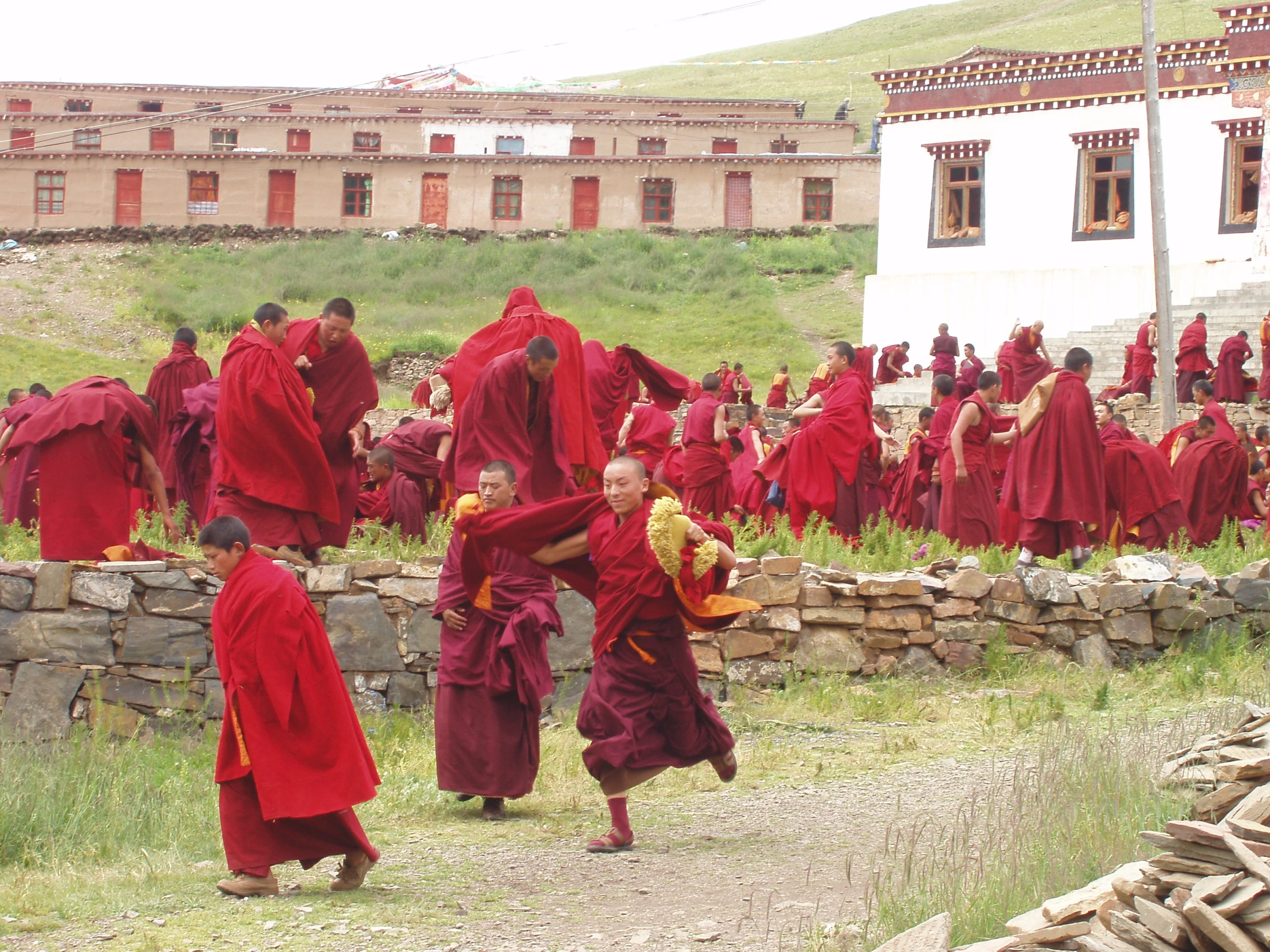 a group of young monks wearing red clothes