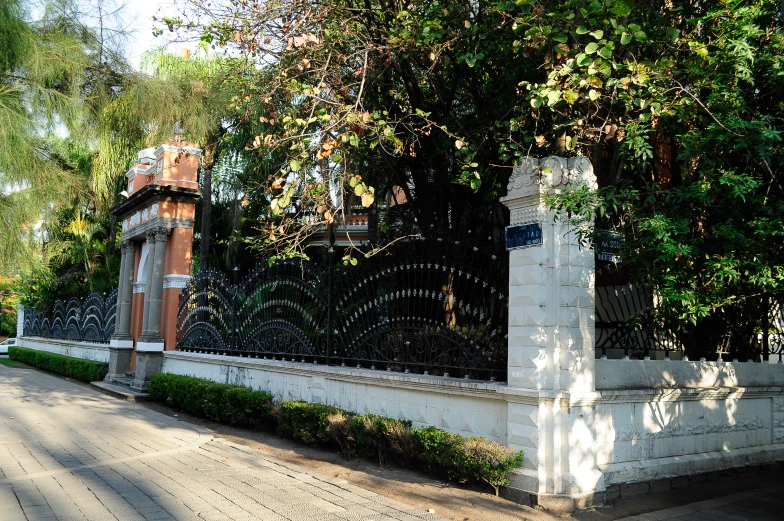 a white picket fence with green trees behind it