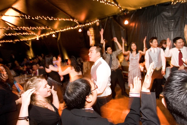 a group of people standing in a crowd on a dance floor